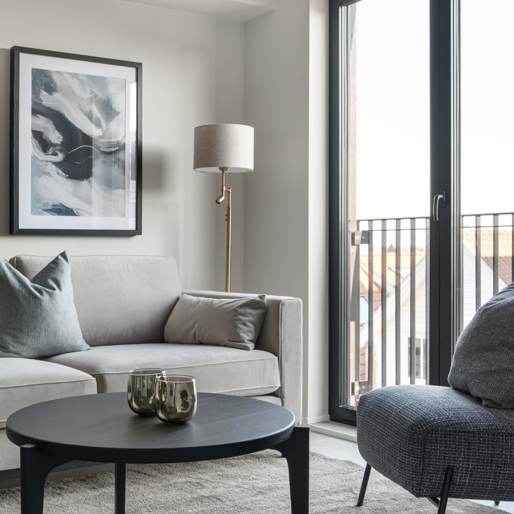 Cozy living room with sofa, coffee table and chair. Nice view in the background. Photo